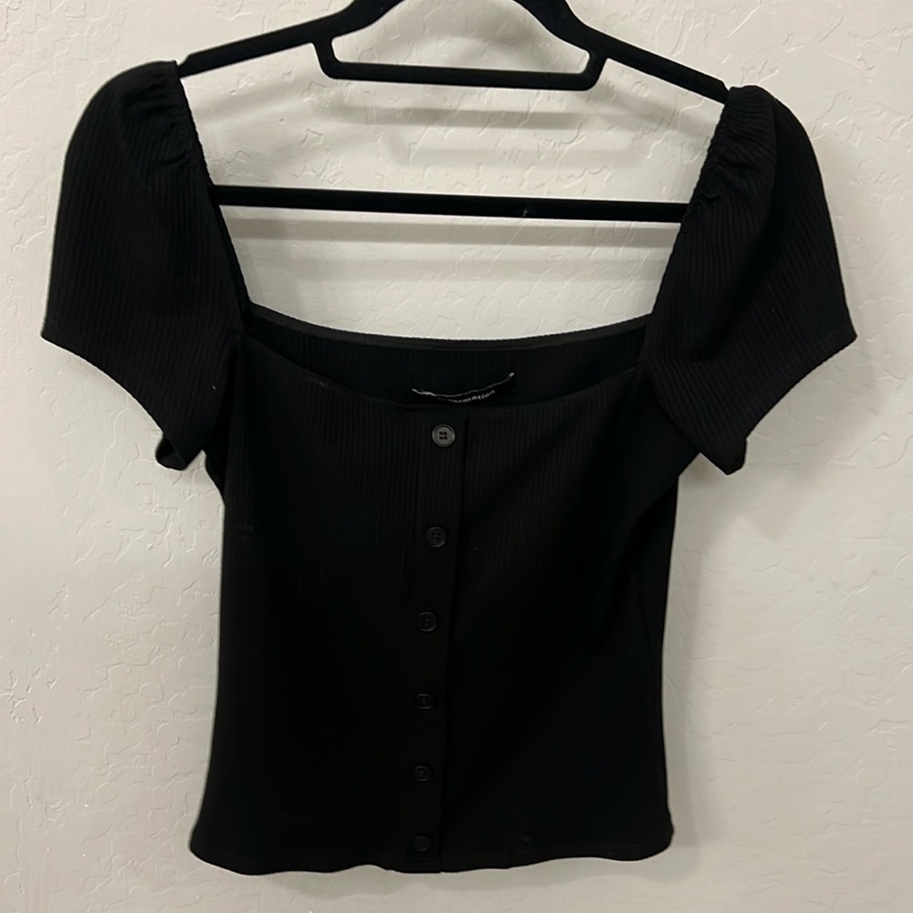 Reformation top button front detail.